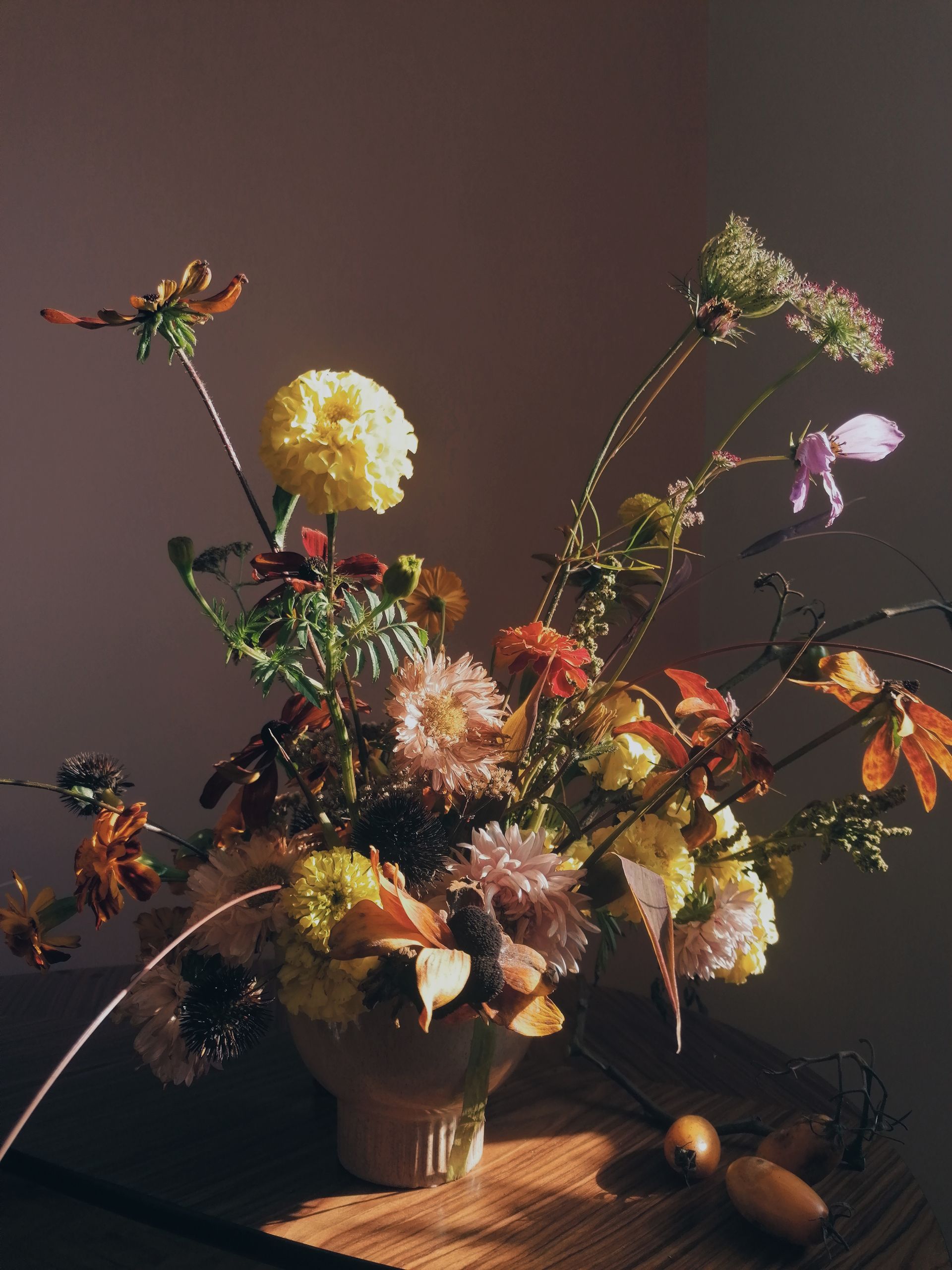 A rustic vase filled with wildflowers, capturing the essence of autumn with warm, earthy tones.