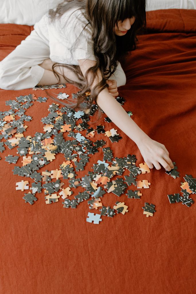 A young child focused on assembling a puzzle, enhancing cognitive skills at home.