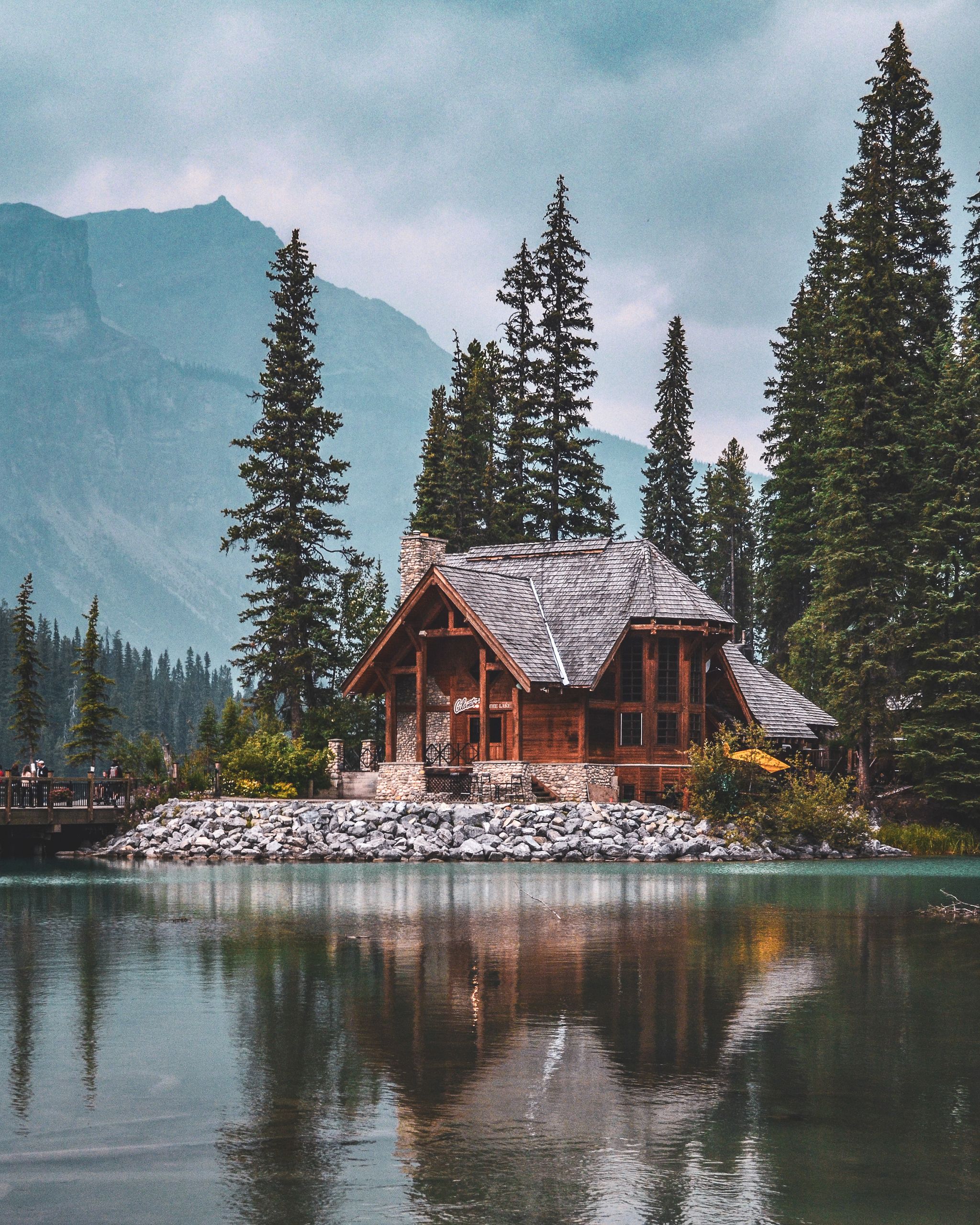 Mountain Lodge surrounded by trees on lake