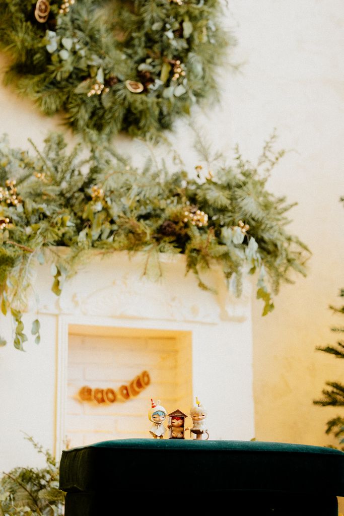 Cozy Christmas scene with wreaths and holiday figurines, perfect for festive ambiance.