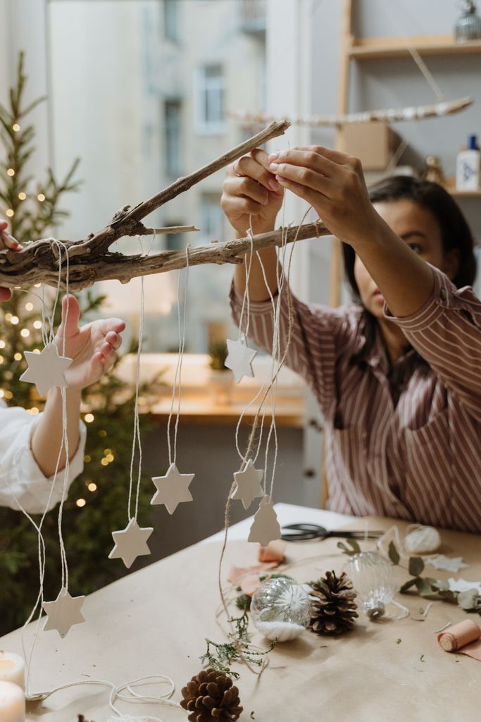 Crafting star-shaped Christmas decorations using natural materials indoors.
