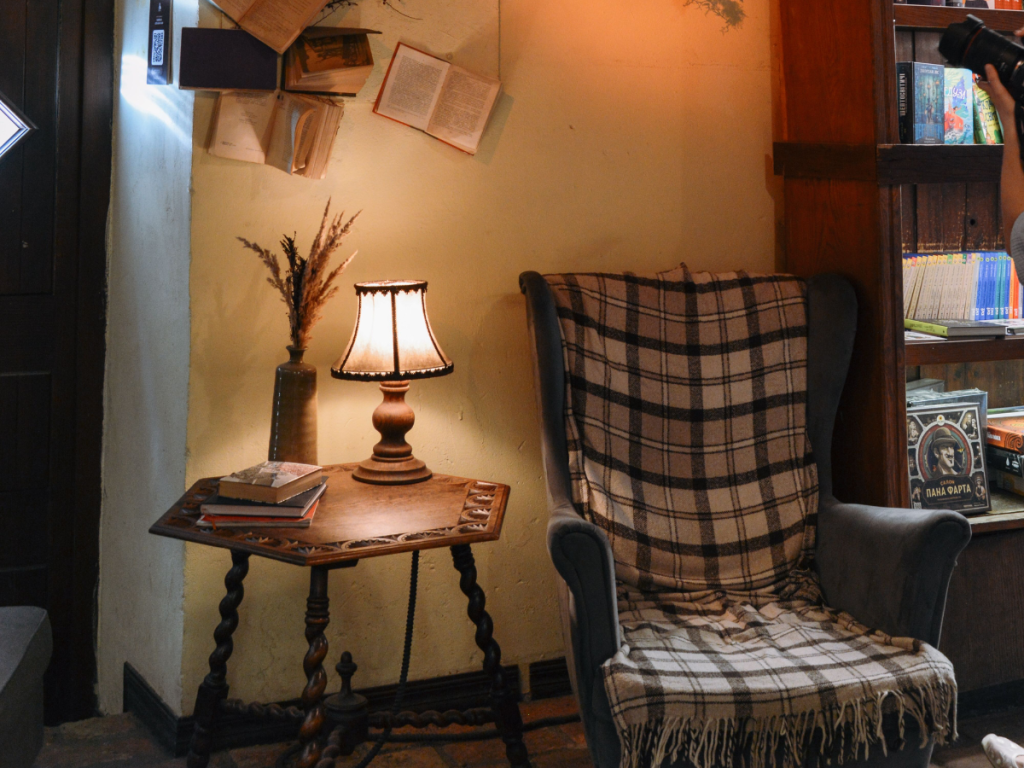 Cottegcore Autumn Reading Nook with warm lamp and vintage armchair