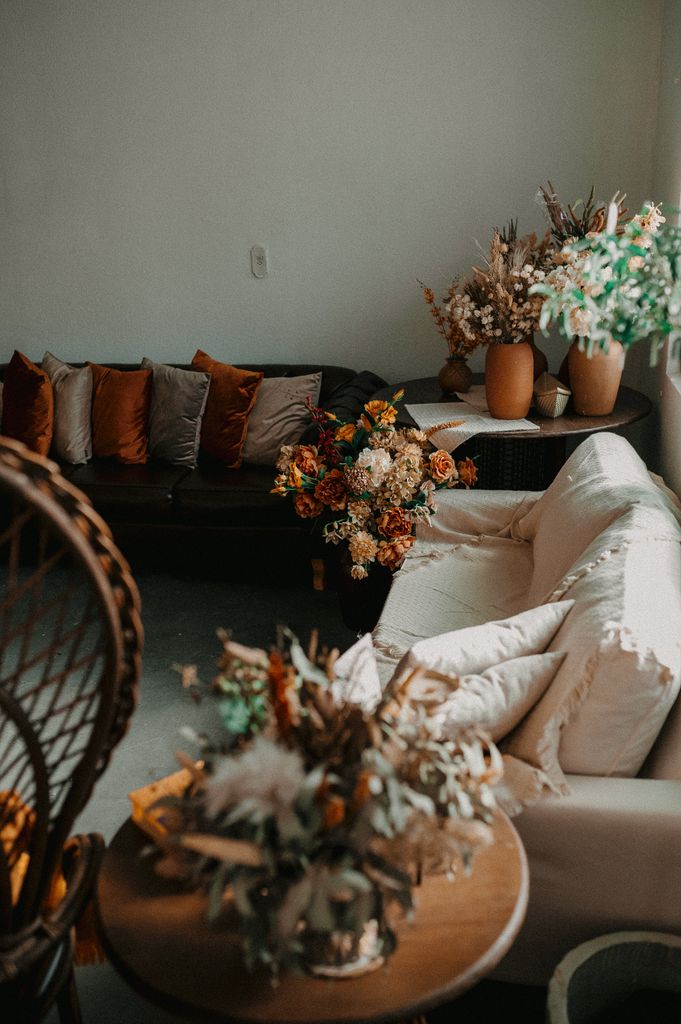 Stylish living room featuring elegant floral arrangements and cozy seating, perfect for relaxation.