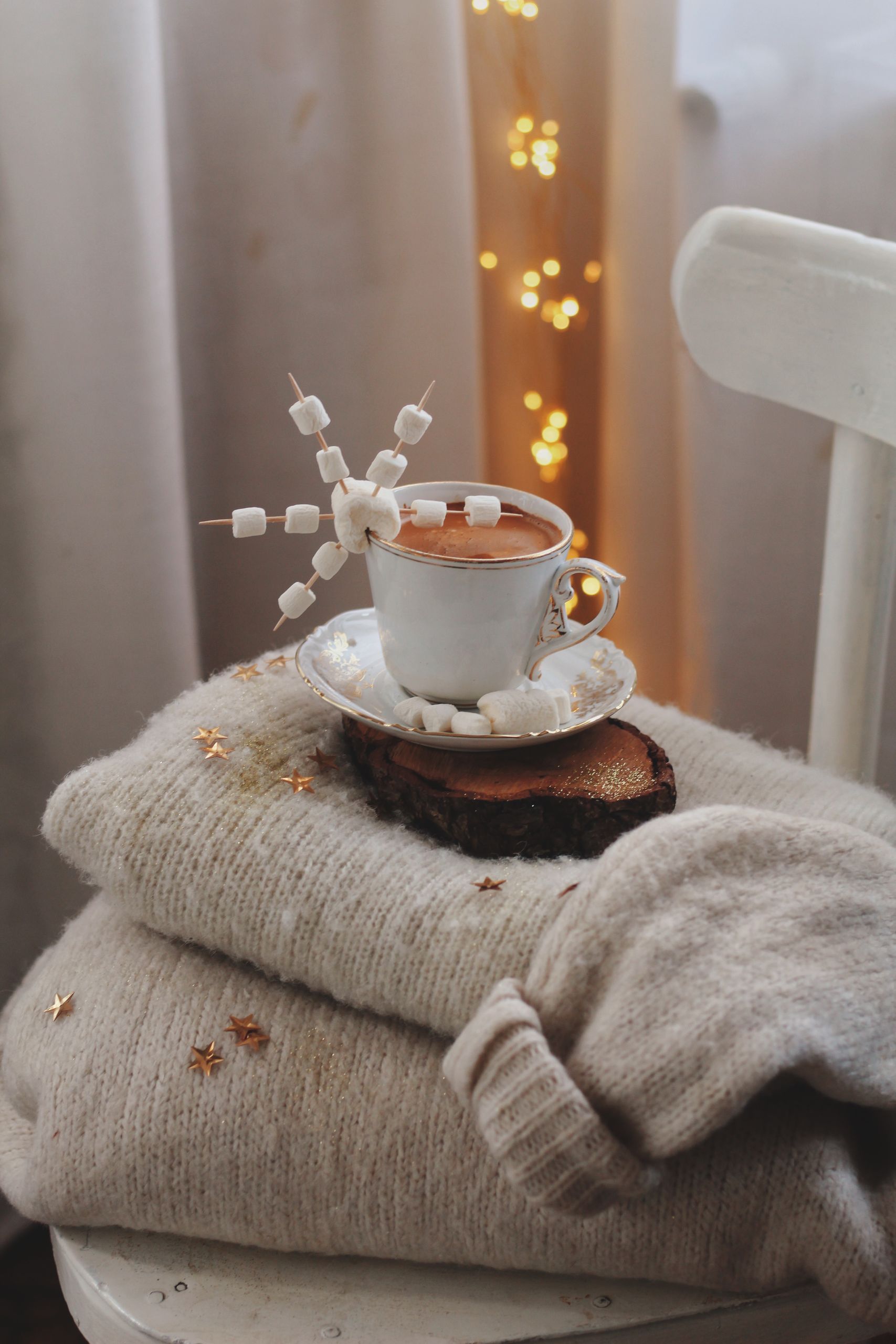 Warm and festive hot chocolate with marshmallows in a cozy winter setting.