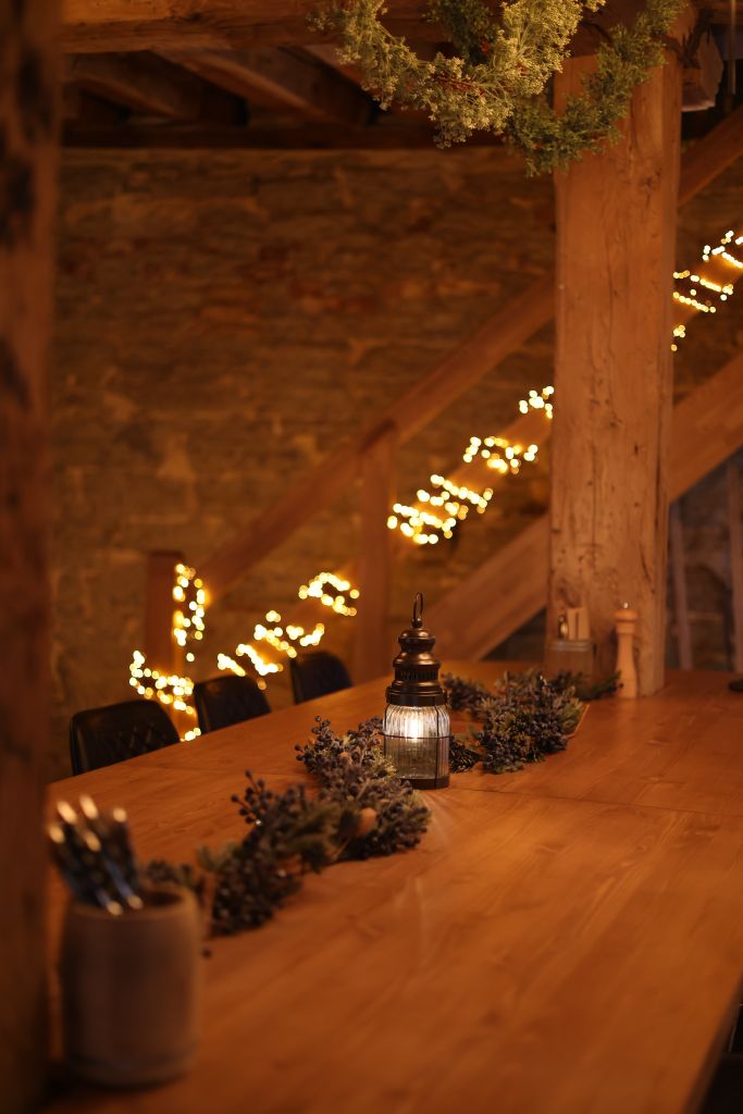 Warm, intimate dining space with rustic wood decor and hanging string lights.