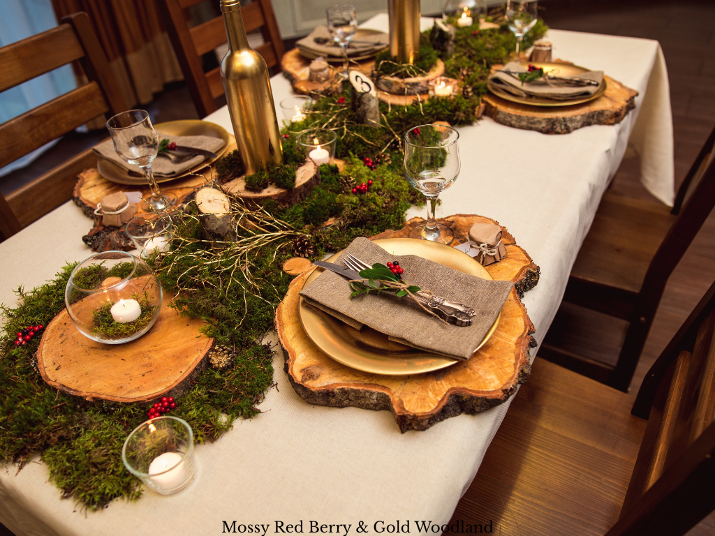 Christmas centerpiece theme with a moss runner, red berries, acorns, gold branches, wood slices, gold bottles and battery candles in gold glass bowls