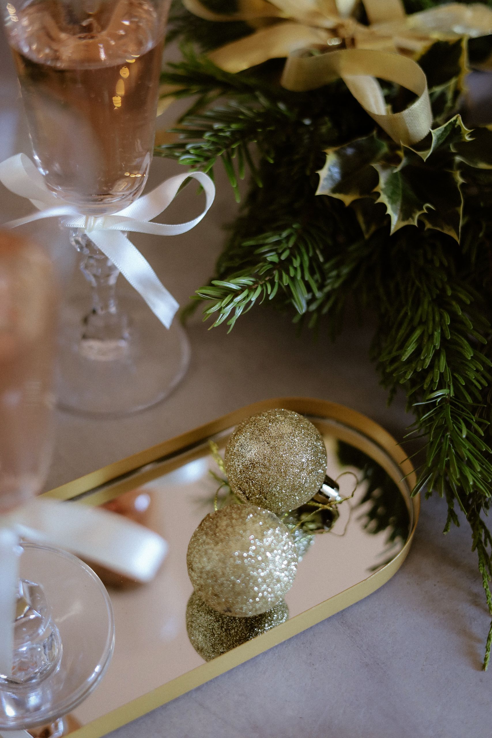 Elegant holiday table setting with champagne and gold ornaments, perfect for celebrations.